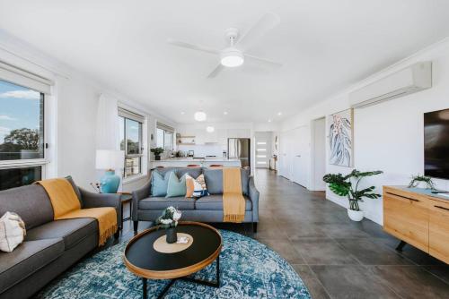 a living room with a couch and a table at Helvetia - Modern Comfort meets Country Convenience in Mudgee