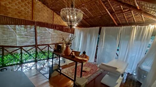 a living room with a large window and a chandelier at GIARDINO ROMANTICO in Dumaguete