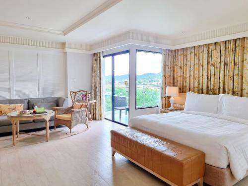 a bedroom with a large bed and a living room at Amari Hua Hin in Hua Hin