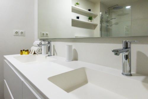 Baño blanco con lavabo y espejo en VACATION MARBELLA I Top 1 Puerto Banus Sea Front Rental, Near Marina en Marbella