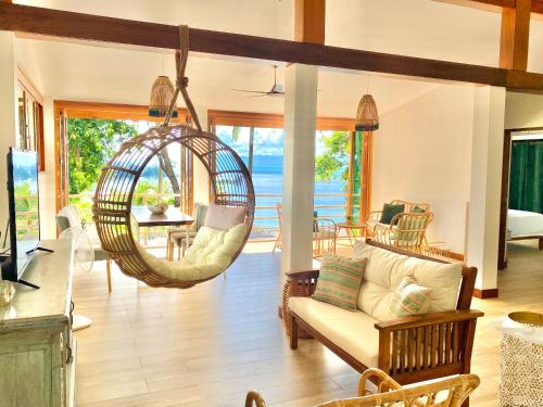 a living room with a couch and a swing at Kalulushi Bungalows in Haad Pleayleam