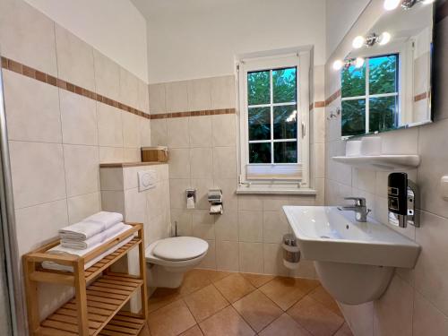 a bathroom with a toilet and a sink at Haus Nordlicht in Ahrenshoop