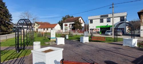a park with a playground and a swing set at Lux Apartmani Novi Park in Vrdnik