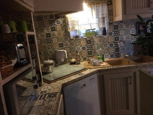 a kitchen with a sink and a counter top at l'Ancienne Forge in Aigonnay