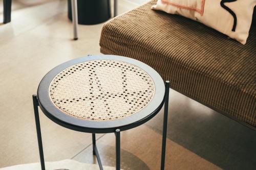 a stool in a living room with a couch at Kiten - slow & work stay - in Atami