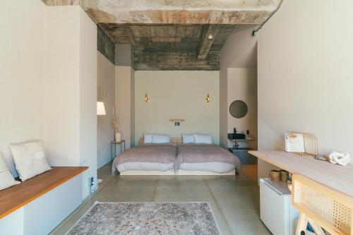 a bedroom with a bed in the middle of it at Kiten - slow & work stay - in Atami