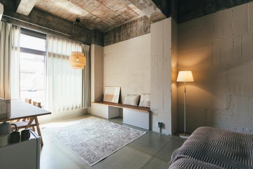 a room with a bed and a table and a window at Kiten - slow & work stay - in Atami