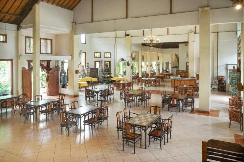 a dining room with tables and chairs and a room with tables at Front One Resort Indraloka Temanggung in Temanggung
