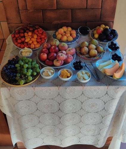 a table with many bowls of fruit on it at B&B Villa Maiolica in San Leone