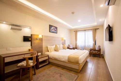 Giường trong phòng chung tại Sarovar Residency Serviced Apartment Hotel