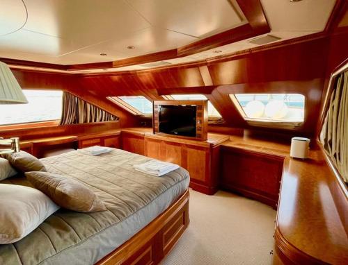a bedroom of a boat with a bed and a tv at GALAKTIKA SKAY YACHT in Hulhumale