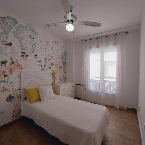 a bedroom with a white bed and a window at Apartamento JALAMA 2B in Moraleja