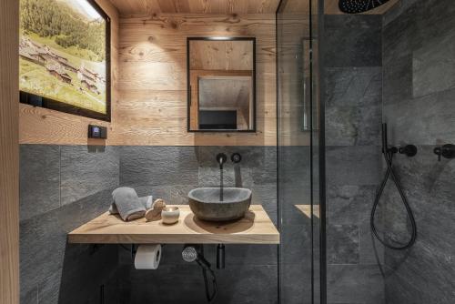 a bathroom with a sink and a shower at Almhütte Tauber Fane Alm in Valles