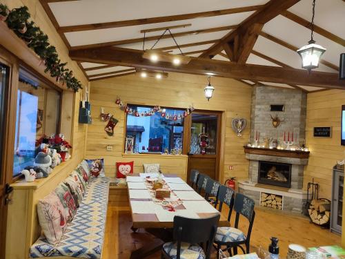 a dining room with a table and a fireplace at Villa Boro in Beli Iskar