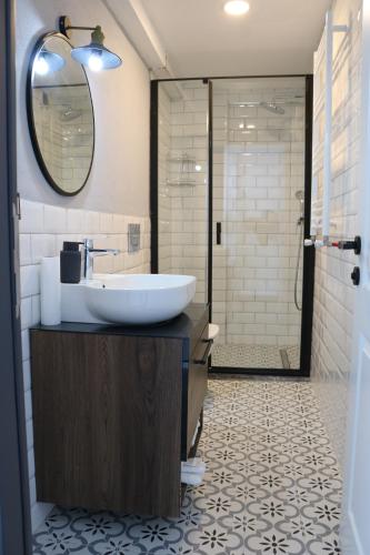 a bathroom with a sink and a shower at Assos Luna Houses in Ayvacık