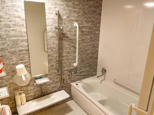 a bathroom with a shower and a white tub at Guest House Ihatov - Vacation STAY 22122v in Takamatsu