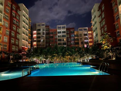 a large swimming pool in a city at night at Studio Apt with Rooftop Panoramic views @ Dabolim in Vasco Da Gama