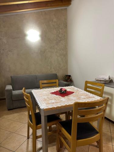 mesa de comedor con sillas y sofá en Appartamento Fiordaliso 1, en Montichiari