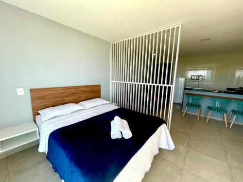 a bedroom with a bed with white shoes on it at Loft Luxo Vista Mar Orla Praia Grande in Arraial do Cabo