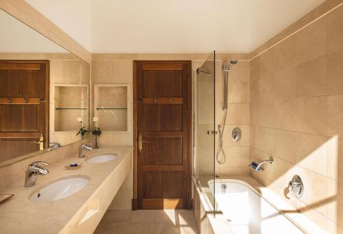 a bathroom with two sinks and a shower at La Residencia, A Belmond Hotel, Mallorca in Deia