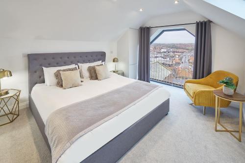 a bedroom with a large bed and a large window at Host & Stay - The Penthouse, Hudsons Yard House in Whitby