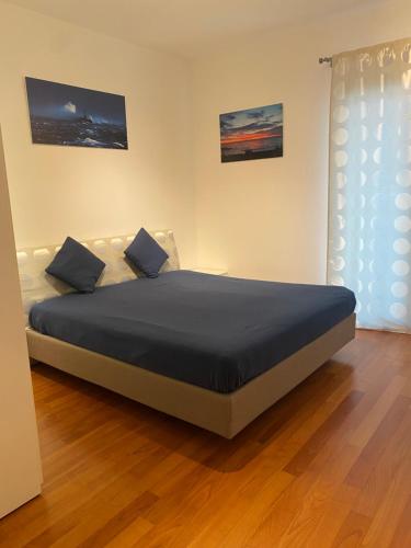 a bedroom with a large bed in a room at RESIDENCE DUINO MARE in Duino