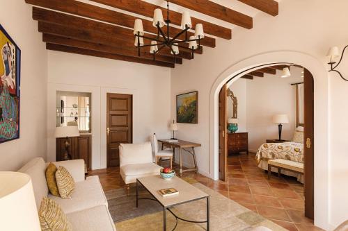 a living room with a couch and a bed at La Residencia, A Belmond Hotel, Mallorca in Deia