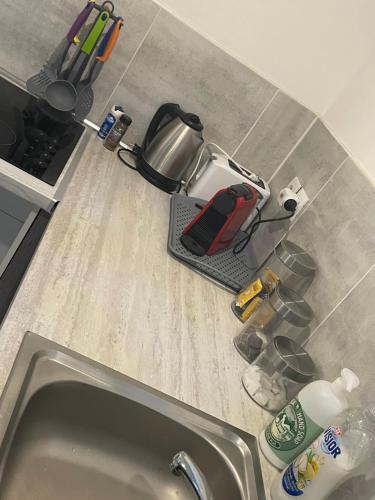 a kitchen counter with a coffee maker on top of it at Le Familiale climatisé & Wi-fi in Paroy-sur-Tholon