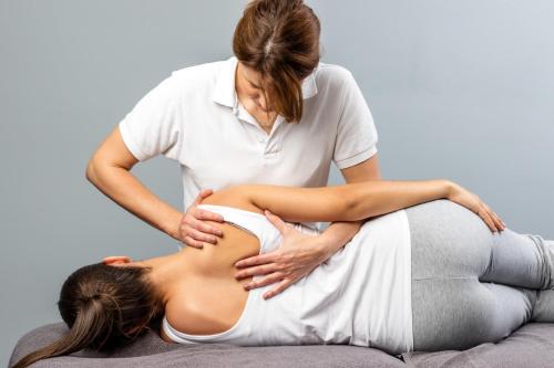 a woman receiving a massage from a therapist at Hotel Nowy Zdrój - Centrum Zdrowia i Wypoczynku in Polanica-Zdrój