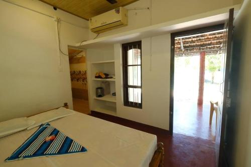 a room with a bed and a door to a patio at Ethus'villahomestay in Mararikulam