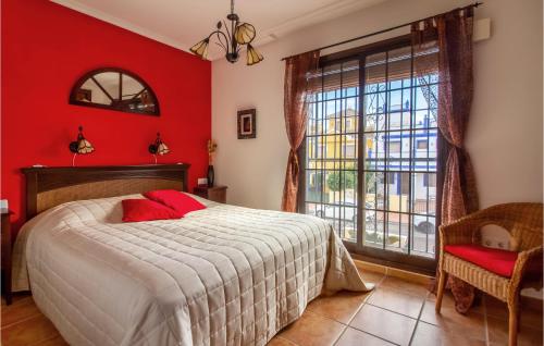 a bedroom with red walls and a bed and a window at Amazing Home In Roda With Wifi in Roda