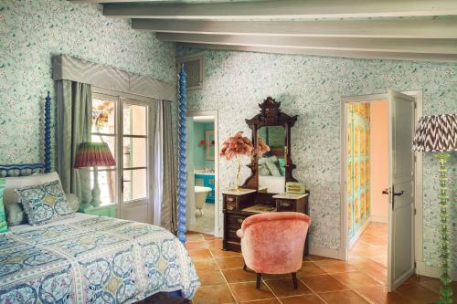 a bedroom with a bed and a mirror at La Residencia, A Belmond Hotel, Mallorca in Deia
