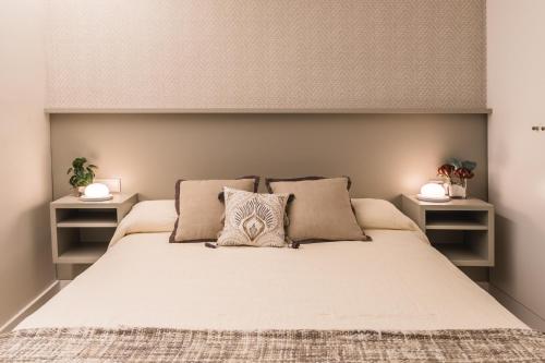 a bedroom with a large bed with two night stands at SIAT VIVIENDAS Villa carretera LA BARROSA in Chiclana de la Frontera