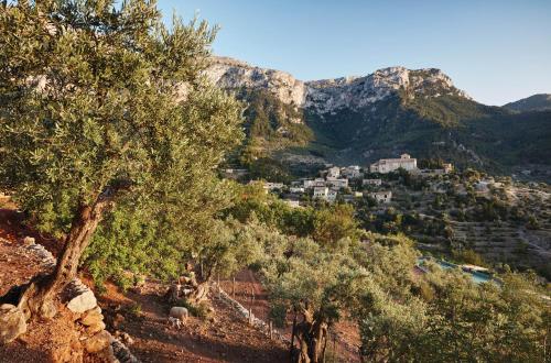 a village on a hill with trees and mountains at La Residencia, A Belmond Hotel, Mallorca in Deia