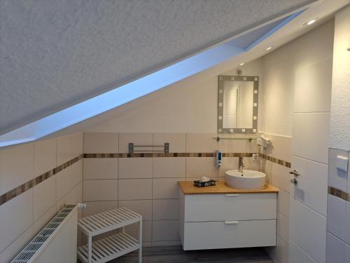 a bathroom with a sink and a mirror at Mertinkus Nordseehotel in Cuxhaven