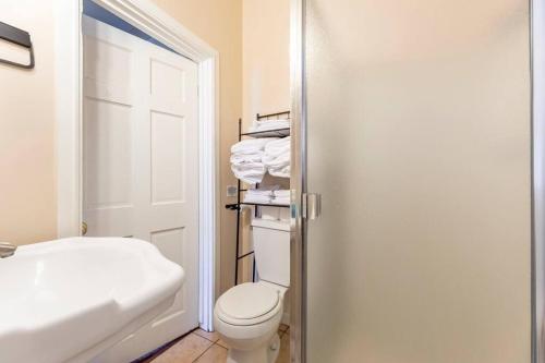 a bathroom with a white toilet and a sink at A+ 2 BR Victorian Home away from Home in Sacramento