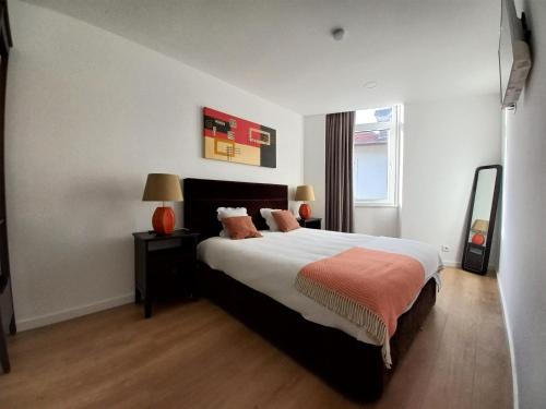 a bedroom with a large bed and a window at Ares do Mar - 4 beds apartment and car parking in Matosinhos