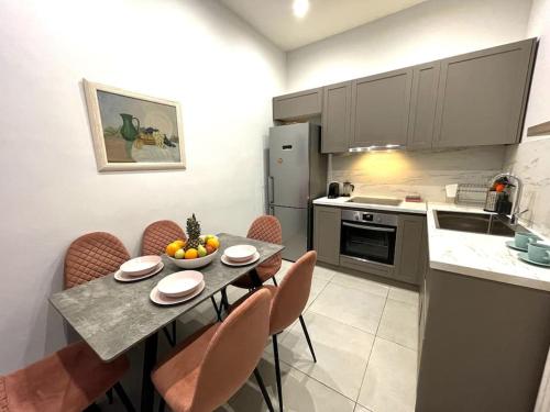 a kitchen with a table and chairs in a kitchen at Maisonette Lucia Traditional House Prime Location in Piraeus