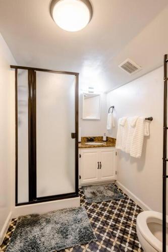 a bathroom with a shower with a toilet and a sink at *2bdr Victorian Home away from Home - *Central Loc in Sacramento