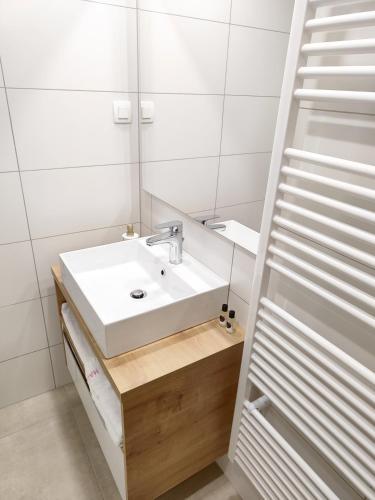 a bathroom with a sink and a mirror at Guesthouse Haler in Podčetrtek
