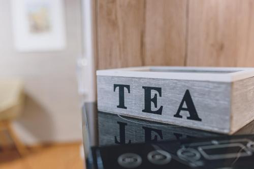 a wooden box with the word tea written on it at Appartements Sulzer by we rent, SUMMERCARD INCLUDED in Zell am See