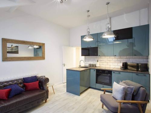 a living room with a couch and a kitchen at Host & Stay - The Surfer's Loft Apartment in Saltburn-by-the-Sea