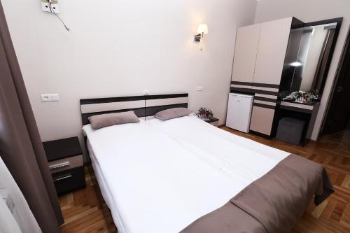 a bedroom with a large white bed in a room at Hotel Tigran Mets Yerevan in Yerevan