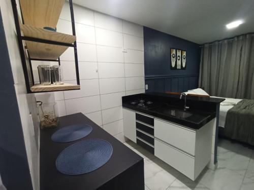cocina pequeña con fregadero y cama en FLAT - 200m da orla do Bessa, en João Pessoa