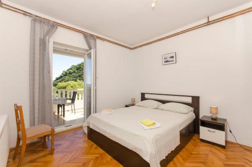 a bedroom with a bed and a large window at Apartment Ruza in Sobra
