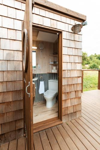 a bathroom with a toilet inside of a building at Luna Domes in Chiddingstone