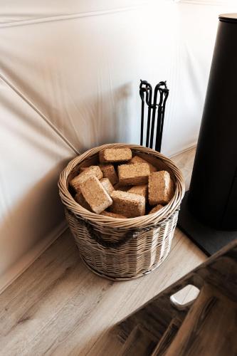 a basket of bread sitting on a table at Luna Domes in Chiddingstone