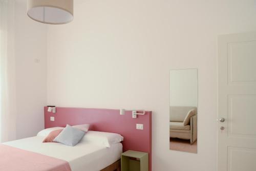 a bedroom with two beds and a mirror at La Rosa rooms & holiday home in Porto SantʼElpidio