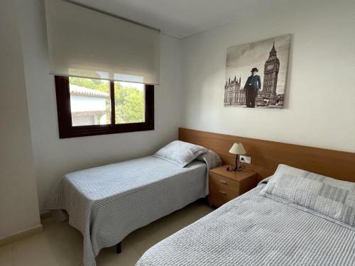 ein Schlafzimmer mit 2 Betten und einem Bild an der Wand in der Unterkunft Bertur Mira d'Or-57 in Peñíscola