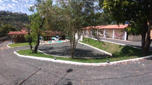 a view of a yard with a pool and trees at Pousada Saint James in Águas de Lindóia